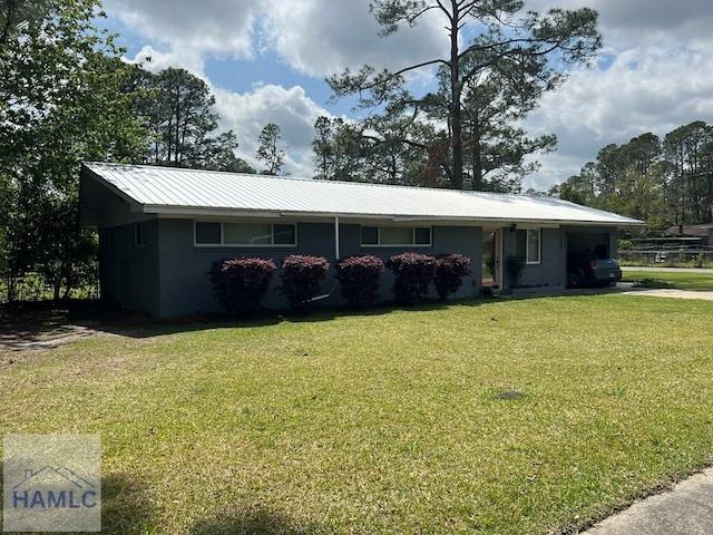 206 Adair St, Jesup, GA 31545 - ranch-style house featuring a front lawn, a metal roof, and an attached garage