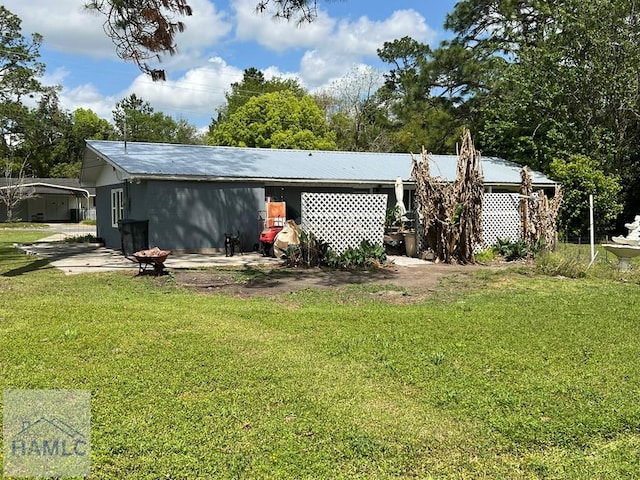 206 Adair St, Jesup, GA 31545 - rear view of property with a yard and a metal roof