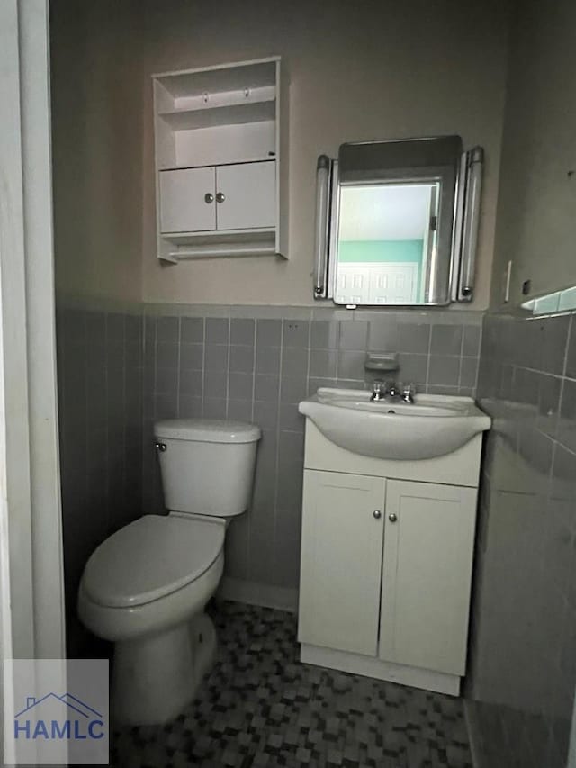 206 Adair St, Jesup, GA 31545 - bathroom featuring tile walls, vanity, and wainscoting