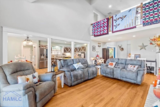 living room with hardwood / wood-style floors and a high ceiling