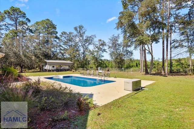 view of swimming pool with a lawn and a patio area