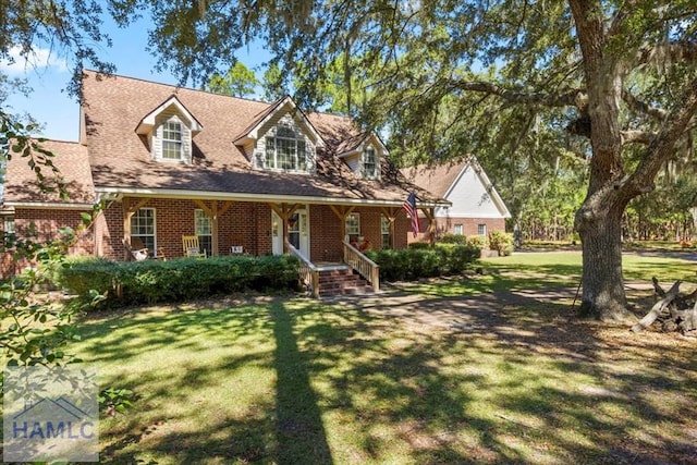 cape cod home with a front yard