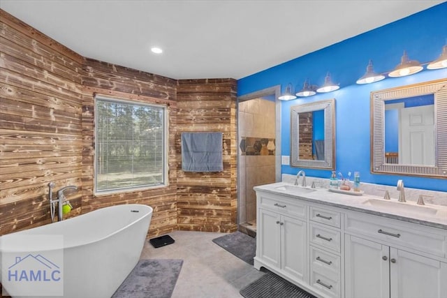 bathroom with separate shower and tub, wood walls, and vanity