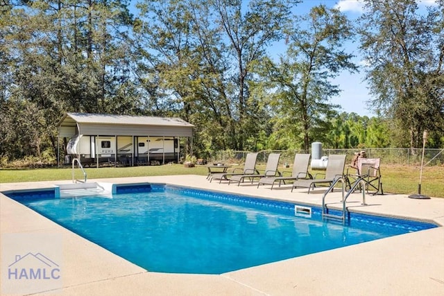 view of swimming pool featuring a lawn and a patio