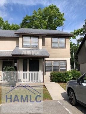 view of front of home with covered porch and metal roof