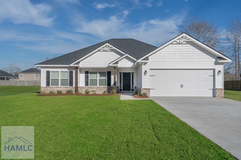 375 Plantation Rd, Midway, GA 31320 - craftsman house with brick siding, a garage, and concrete driveway