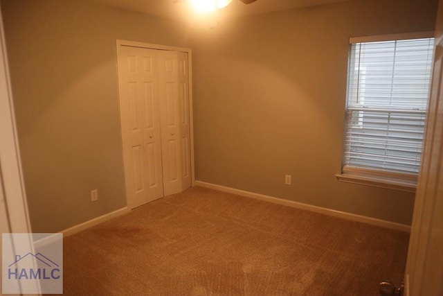 unfurnished room featuring carpet and ceiling fan