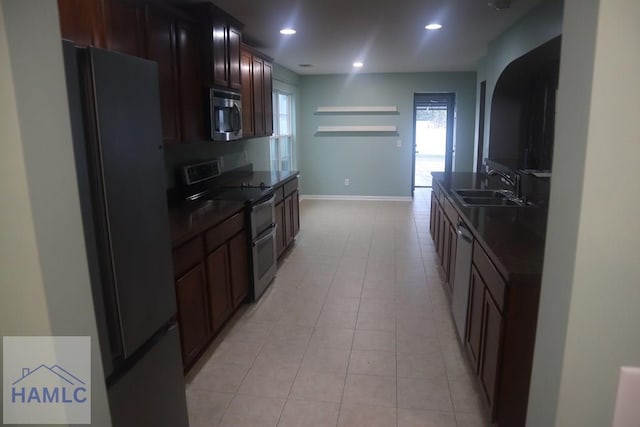 kitchen featuring sink, light tile patterned floors, and stainless steel appliances