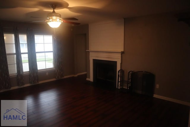 unfurnished living room with ceiling fan and dark hardwood / wood-style flooring