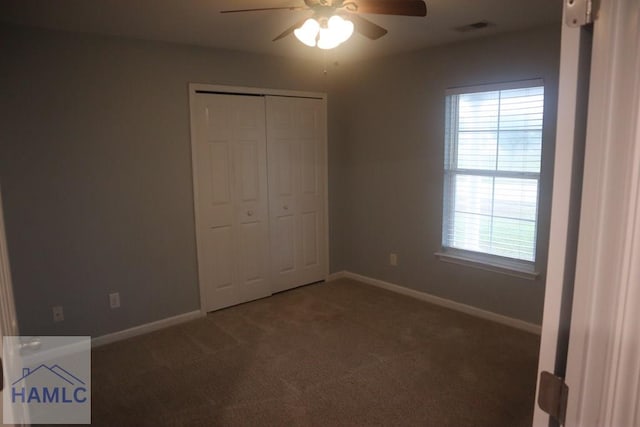 unfurnished bedroom with carpet flooring, ceiling fan, and a closet