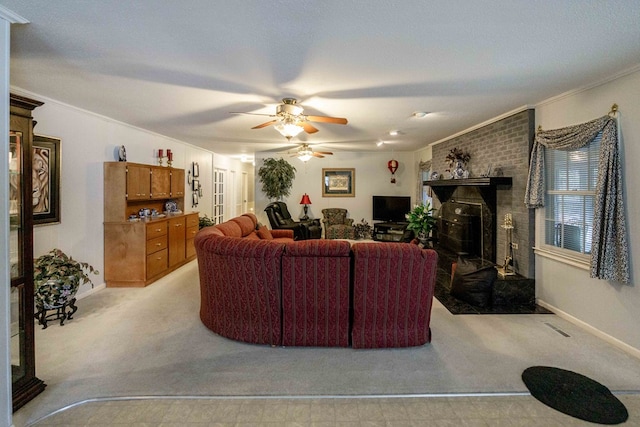 carpeted living room with a brick fireplace, crown molding, and ceiling fan