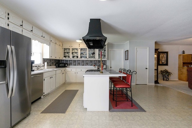 kitchen with sink, island range hood, a kitchen breakfast bar, stainless steel appliances, and a kitchen island with sink