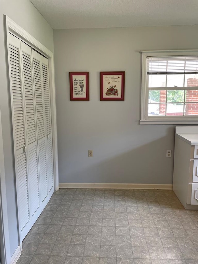 unfurnished bedroom with a closet and a textured ceiling