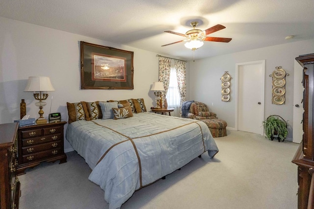 carpeted bedroom with a textured ceiling and ceiling fan