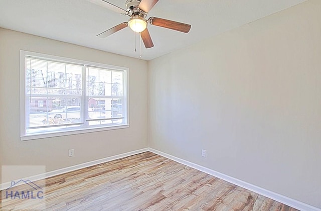 unfurnished room featuring a ceiling fan, baseboards, and wood finished floors