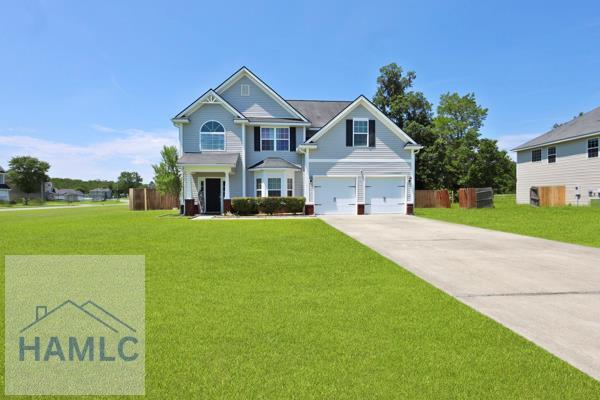 246 Cumberland Dr NE, Ludowici, GA 31316 - view of front facade featuring driveway and an attached garage