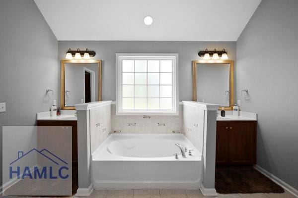 246 Cumberland Dr NE, Ludowici, GA 31316 - bathroom with a bath, two vanities, and lofted ceiling