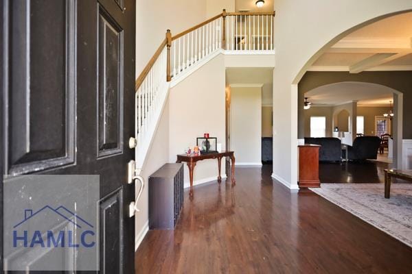 246 Cumberland Dr NE, Ludowici, GA 31316 - foyer with wood finished floors, a high ceiling, a ceiling fan, arched walkways, and stairway