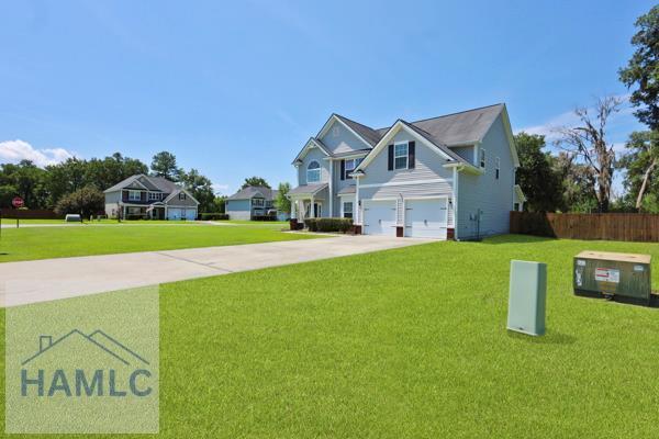 246 Cumberland Dr NE, Ludowici, GA 31316 - view of front of home with an attached garage and driveway