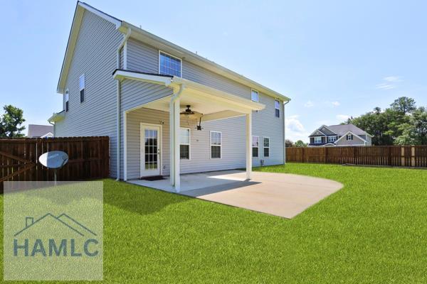 246 Cumberland Dr NE, Ludowici, GA 31316 - back of house featuring a fenced backyard, a patio, and ceiling fan