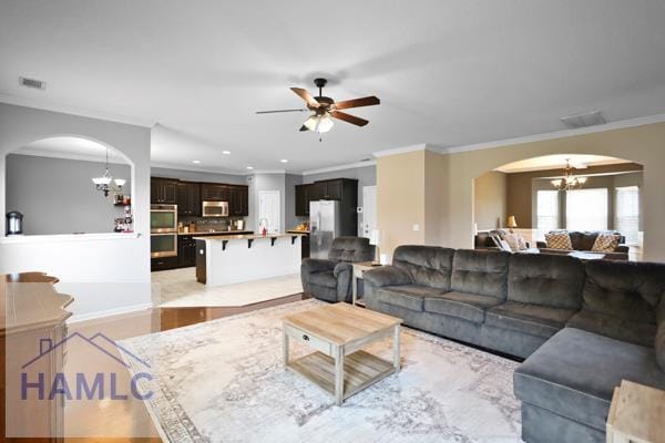 246 Cumberland Dr NE, Ludowici, GA 31316 - living area featuring a chandelier, arched walkways, crown molding, a ceiling fan, and recessed lighting