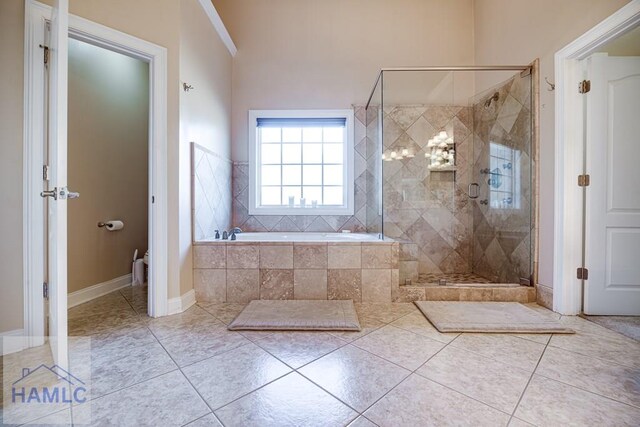 86 Brigham Dr, Richmond Hill, GA 31324 - bathroom with a garden tub, a shower stall, tile patterned floors, and baseboards