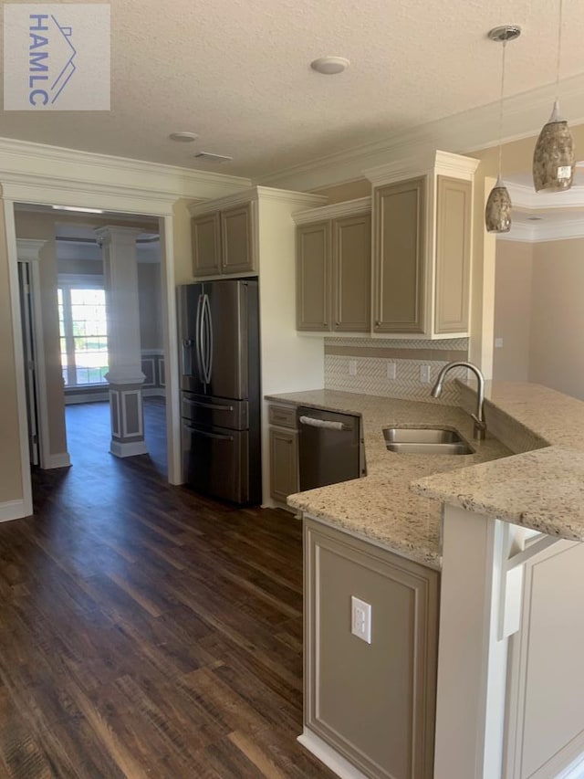 kitchen with a sink, light stone countertops, crown molding, appliances with stainless steel finishes, and dark wood-style flooring