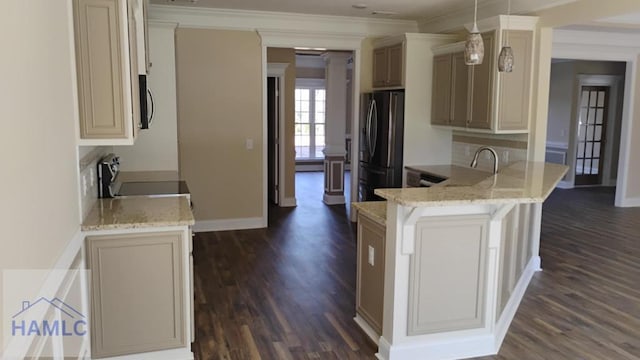 kitchen featuring light stone counters, appliances with stainless steel finishes, dark wood finished floors, a peninsula, and ornamental molding