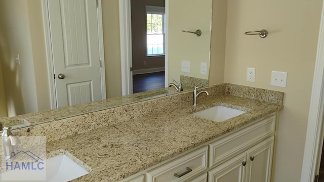 bathroom featuring a sink and double vanity