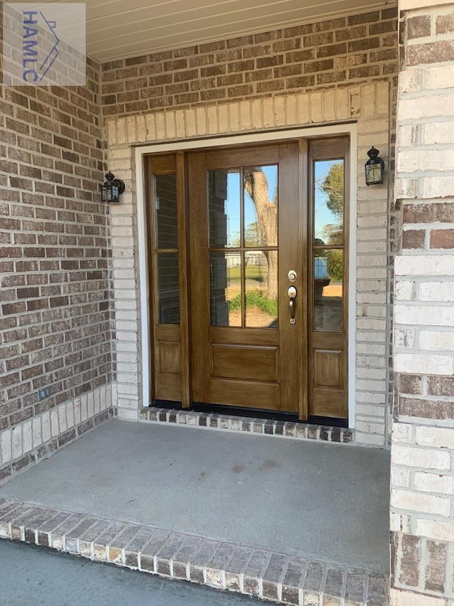 property entrance featuring brick siding