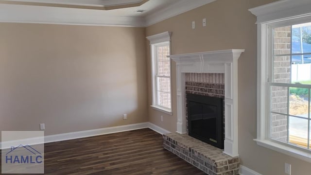 unfurnished living room with crown molding, baseboards, a fireplace, and dark wood-style flooring