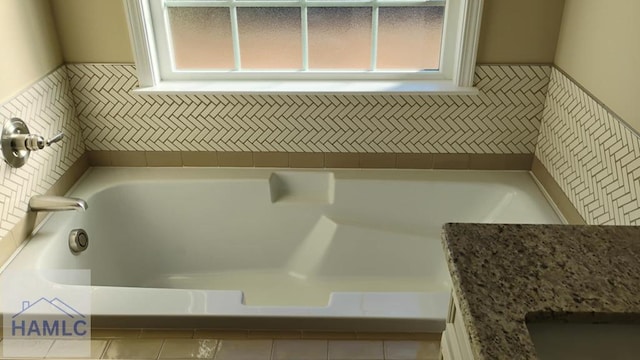 full bathroom featuring a bath and a wealth of natural light