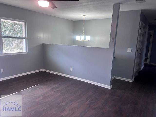 empty room with ceiling fan, baseboards, and wood finished floors