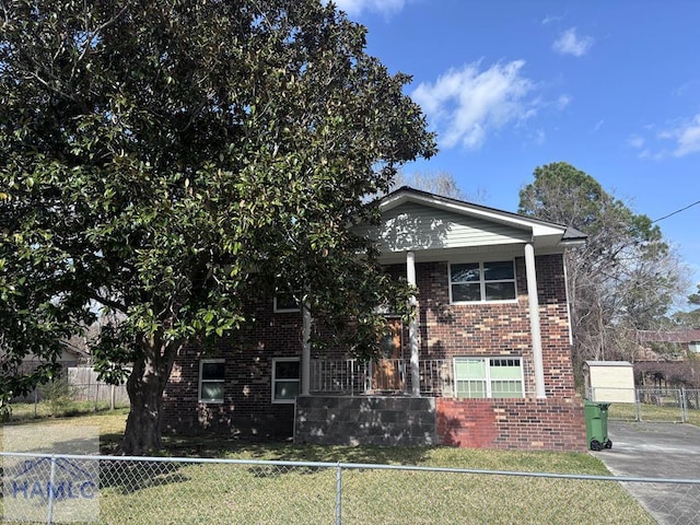 view of front of house with brick siding and a fenced front yard