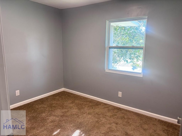 spare room featuring baseboards and carpet floors