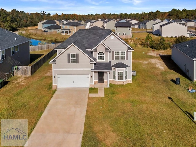 view of front of home featuring a garage and a front lawn