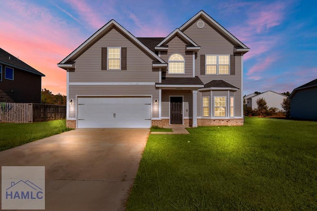 front facade with a lawn and a garage