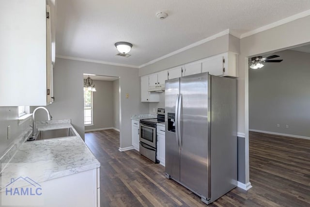 kitchen with a sink, stainless steel appliances, light countertops, white cabinets, and crown molding