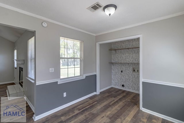 washroom featuring visible vents, a fireplace, baseboards, and wood finished floors