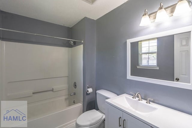 bathroom featuring toilet, shower / washtub combination, and vanity