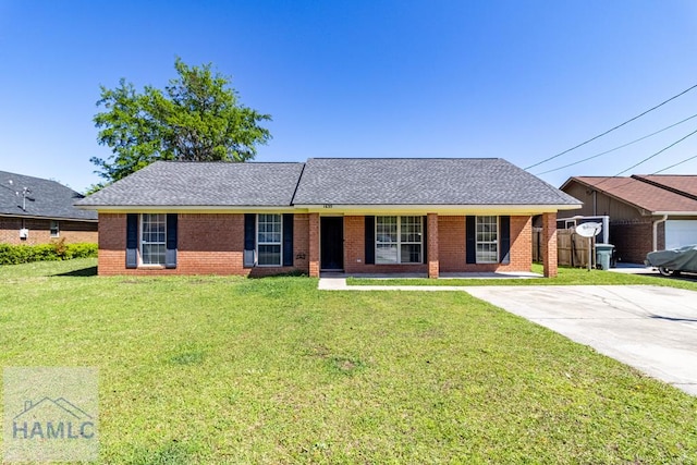 ranch-style house with brick siding, a shingled roof, and a front lawn