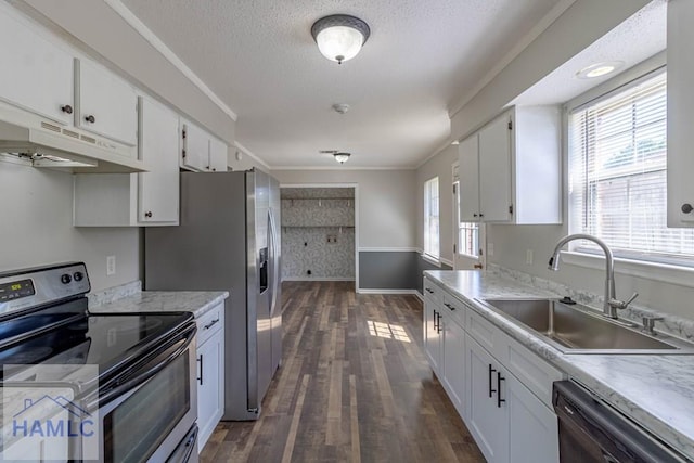 kitchen with stainless steel electric range, a sink, black dishwasher, under cabinet range hood, and white cabinetry