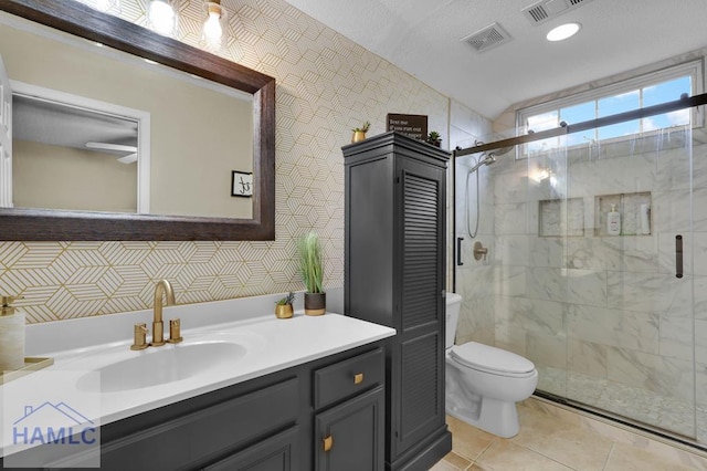 bathroom featuring toilet, a shower with shower door, lofted ceiling, and vanity