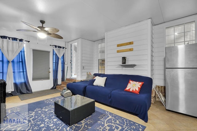 living room featuring tile patterned flooring and ceiling fan