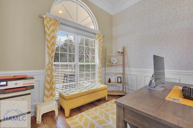 living area featuring crown molding and hardwood / wood-style flooring