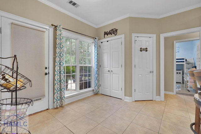 tiled foyer entrance featuring ornamental molding