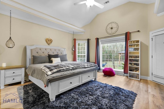 bedroom with ceiling fan, lofted ceiling, and light wood-type flooring