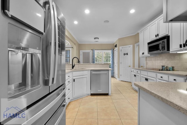 kitchen featuring white cabinets, appliances with stainless steel finishes, sink, and tasteful backsplash