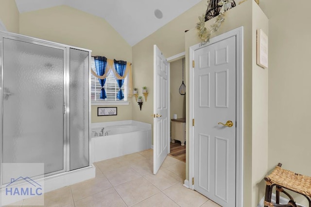 bathroom with separate shower and tub, tile patterned floors, and lofted ceiling