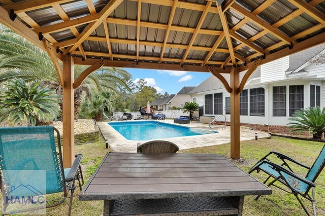 view of swimming pool featuring a lawn, a gazebo, and a patio